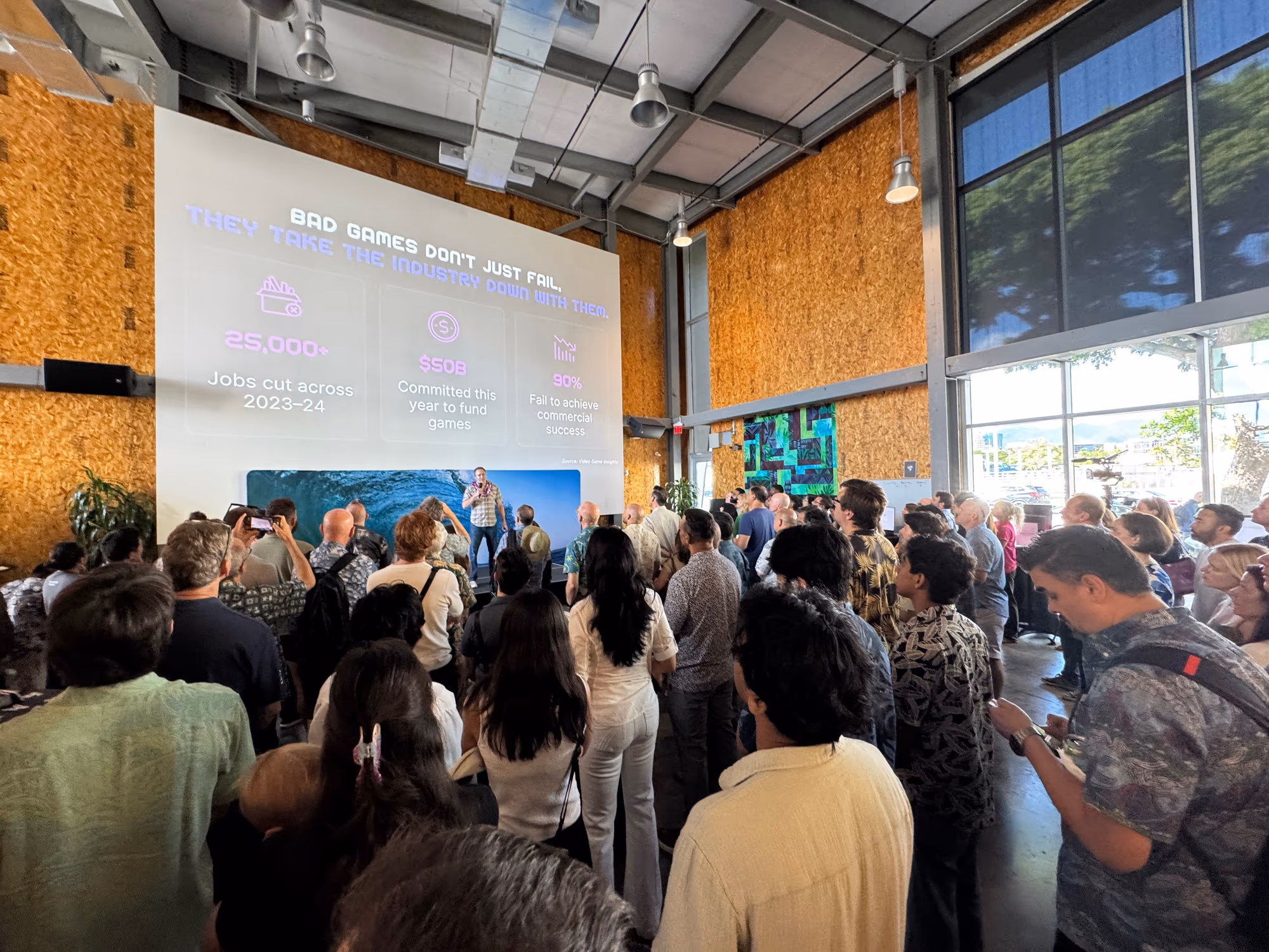 A standing audience watches a startup presentation at Entrepreneurs Sandbox.