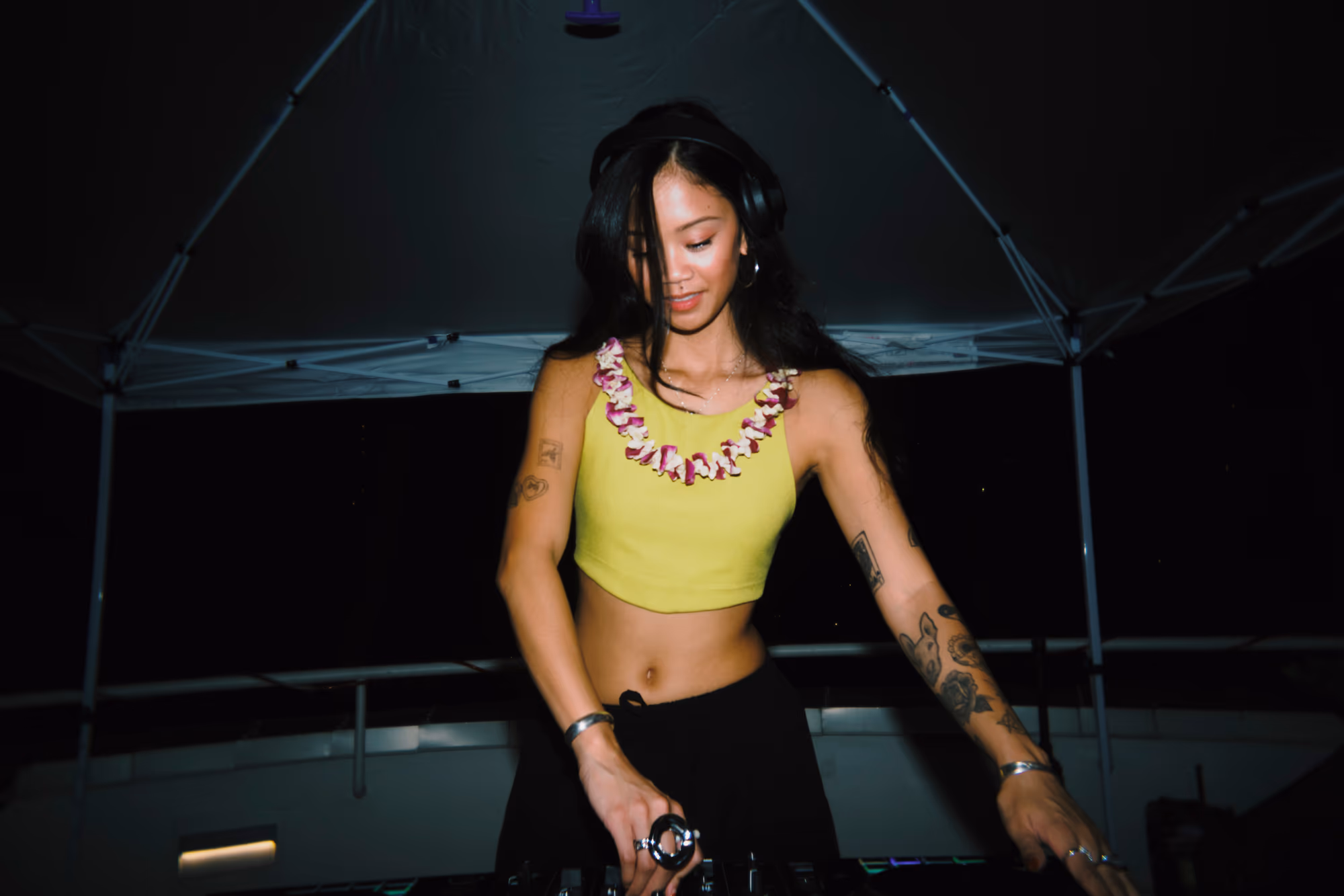 A DJ wearing headphones performs at the official kickoff party.