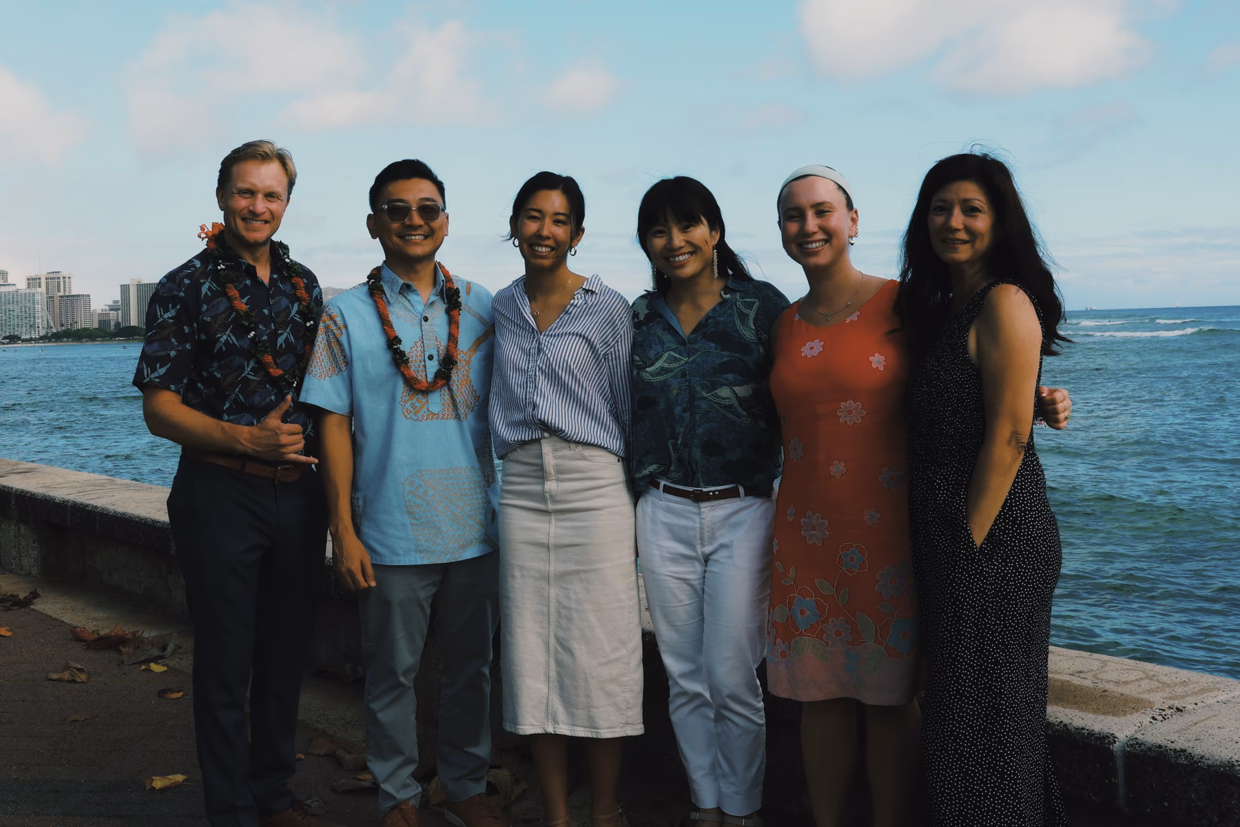 Participants pose together beside the ocean at the ocean innovation event.