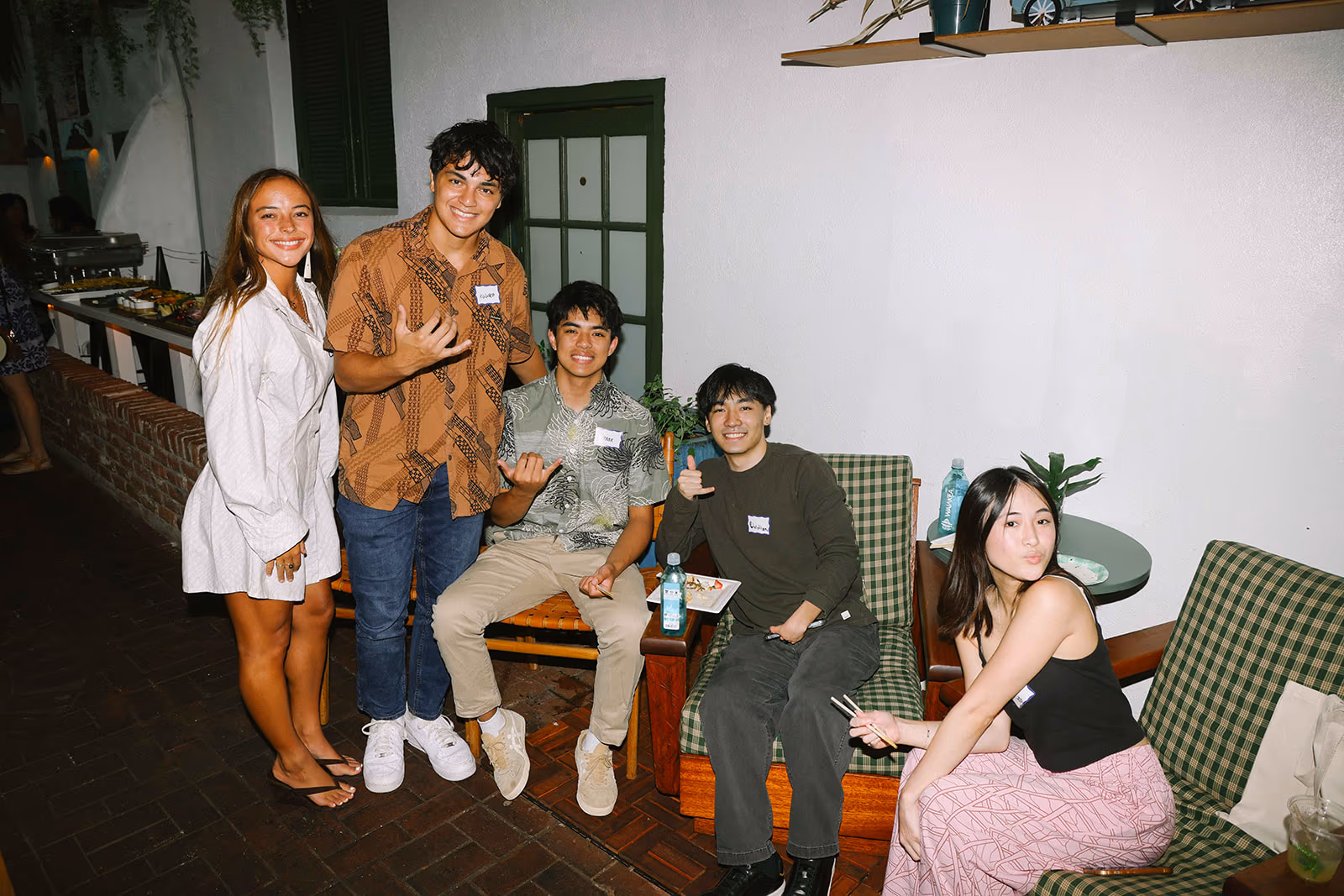 Five participants gather and make shaka gestures at the Pasifika in Tech event.